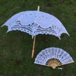 white lace umbrella and lace fan